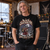 Black Sackbeth Christmas T-shirt worn by a mature rock fan in a festive rehearsal studio