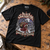 Black Sackbeth Christmas T-shirt on an oak workbench with approved NEWTZ neck print