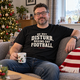 Do Not Disturb Boxing Day Football black Christmas T-shirt worn in a relaxed living room
