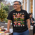 Man wearing the black NEWTZ Christmas Creature Chaos T-shirt at a garden Christmas get-together