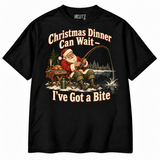 Christmas Dinner Can Wait — I've Got a Bite Christmas fishing T-shirt in Black, studio view on white background