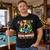 Hoah Momma Christmas T-shirt worn by an adult man in a festive games room