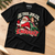 Is This Jolly Enough Christmas T-shirt on an oak workbench