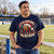 It's Coming Ho Ho Home Christmas Football T-Shirt — model at a football ground