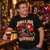 Jingle Jovi Christmas T-shirt worn by a rock fan in a festive music pub