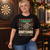 Merry Dartsmas Christmas Darts T-Shirt — woman wearing the black tee at a festive darts club