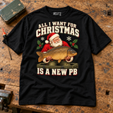 New PB Christmas carp fishing T-shirt — flat lay on wooden workbench