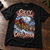 NEWTZ Crazy Sleigh Christmas T-shirt laid flat on a rustic studio workbench