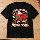 Santa’s Got a Massive Package Christmas T-shirt flat on an oak workbench