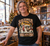 Sled Zeppelin Christmas T-shirt worn by an adult man in a festive record shop